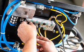 An employee carries out the assembly and wires the components